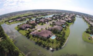 Aerial view of suburban homes next to water channels showing flood zone areas where a FEMA Elevation Certificate may be required for closing