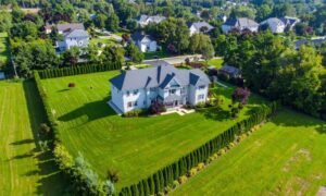Aerial view of a large residential property with clear yard boundaries, showing why a due diligence survey helps confirm the true size of the land