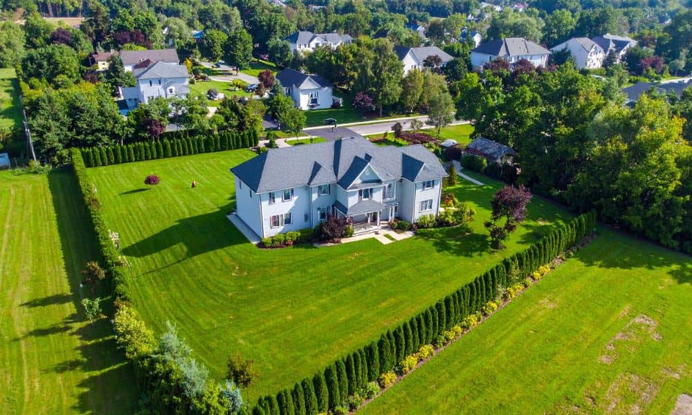 Aerial view of a large residential property with clear yard boundaries, showing why a due diligence survey helps confirm the true size of the land