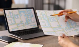 A professional reviewing a property map as part of ALTA land title surveys to confirm boundaries and verify land records