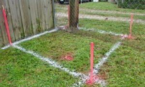 Boundary surveys showing clearly marked property lines with survey stakes next to a residential fence