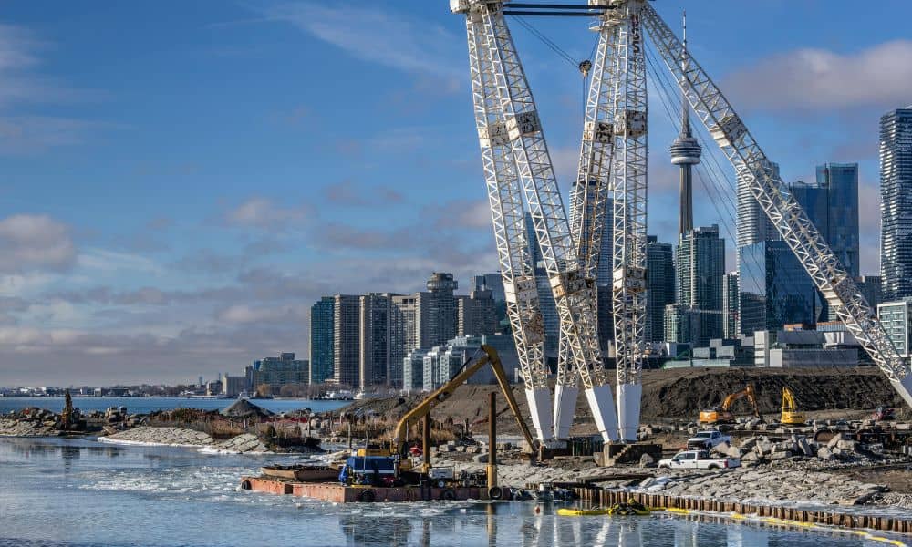 Construction activity on a riverfront redevelopment site where a construction survey guides accurate building placement