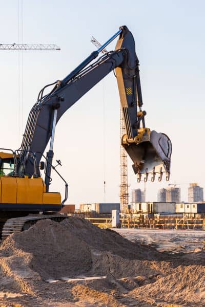 Construction site delay alta title survey - ALTA SURVEY New York Excavator idle on a construction site symbolizing project delays caused by OPUS slowdown affecting ALTA Title Survey schedules