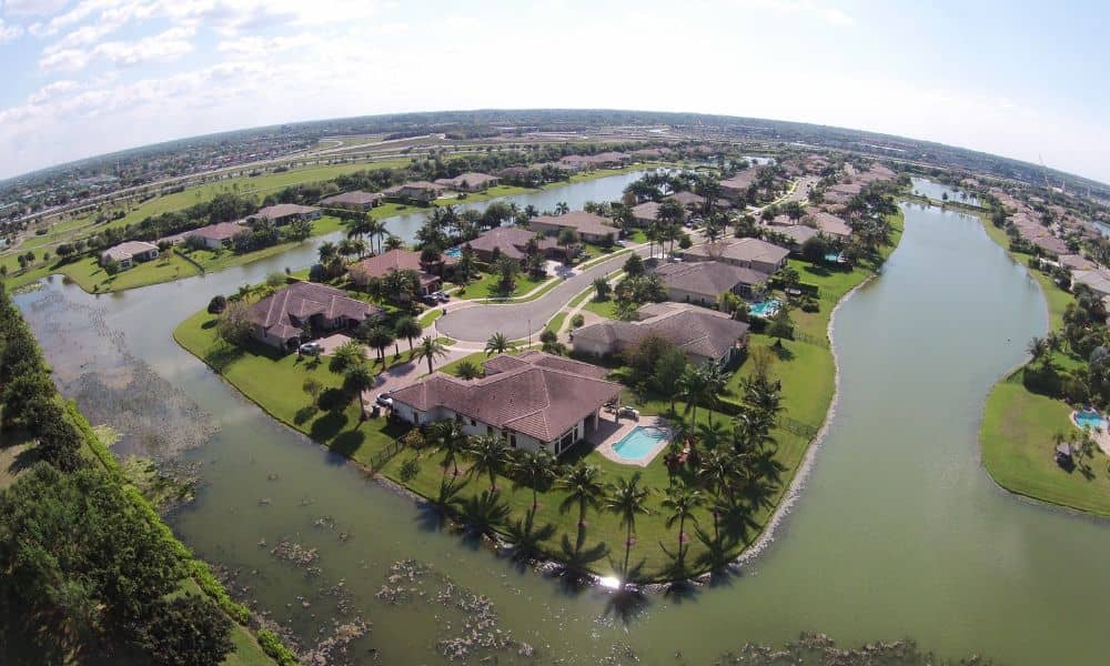 Fema elevation certificate flood zone homes - ALTA SURVEY New York Aerial view of suburban homes next to water channels showing flood zone areas where a FEMA Elevation Certificate may be required for closing