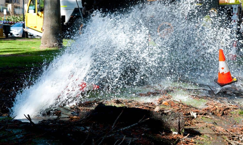 Water main break flooding a city street, showing why lidar mapping is critical for understanding underground infrastructure