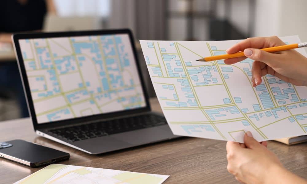 A professional reviewing a property map as part of ALTA land title surveys to confirm boundaries and verify land records