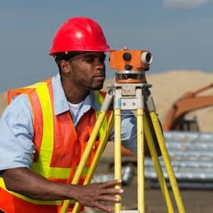 Licensed land surveyor verifying site measurements to support accurate drone surveying results