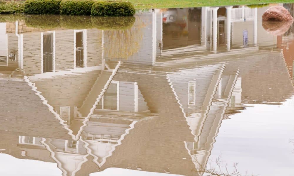 Flooded residential yard after heavy rain - ALTA SURVEY New York Flooded yard near a home after heavy rain showing why an ALTA survey helps identify property risks